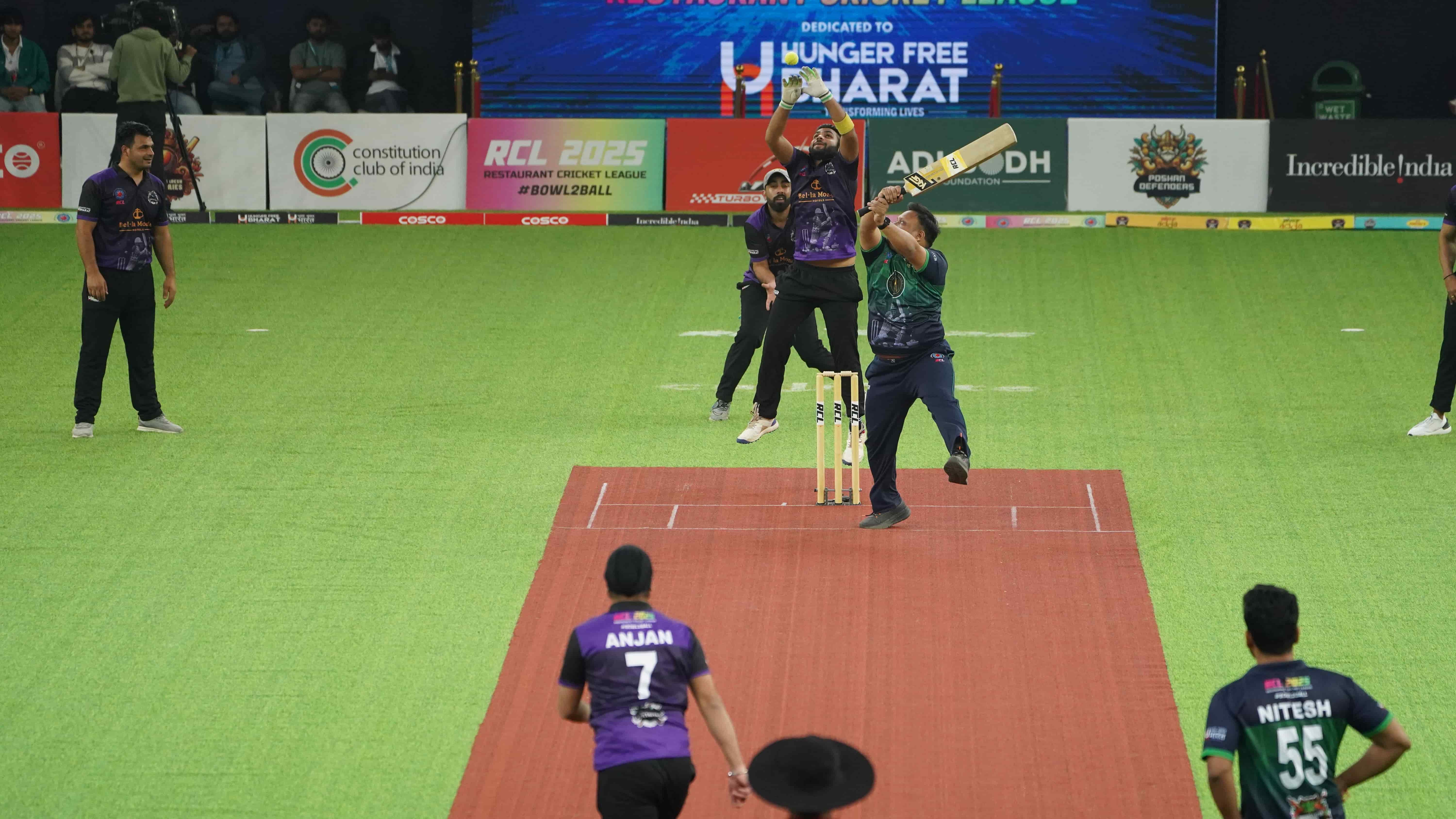 Batsman mid-shot with HFB jersey branding